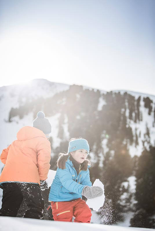 Kids in the snow - building a snowman